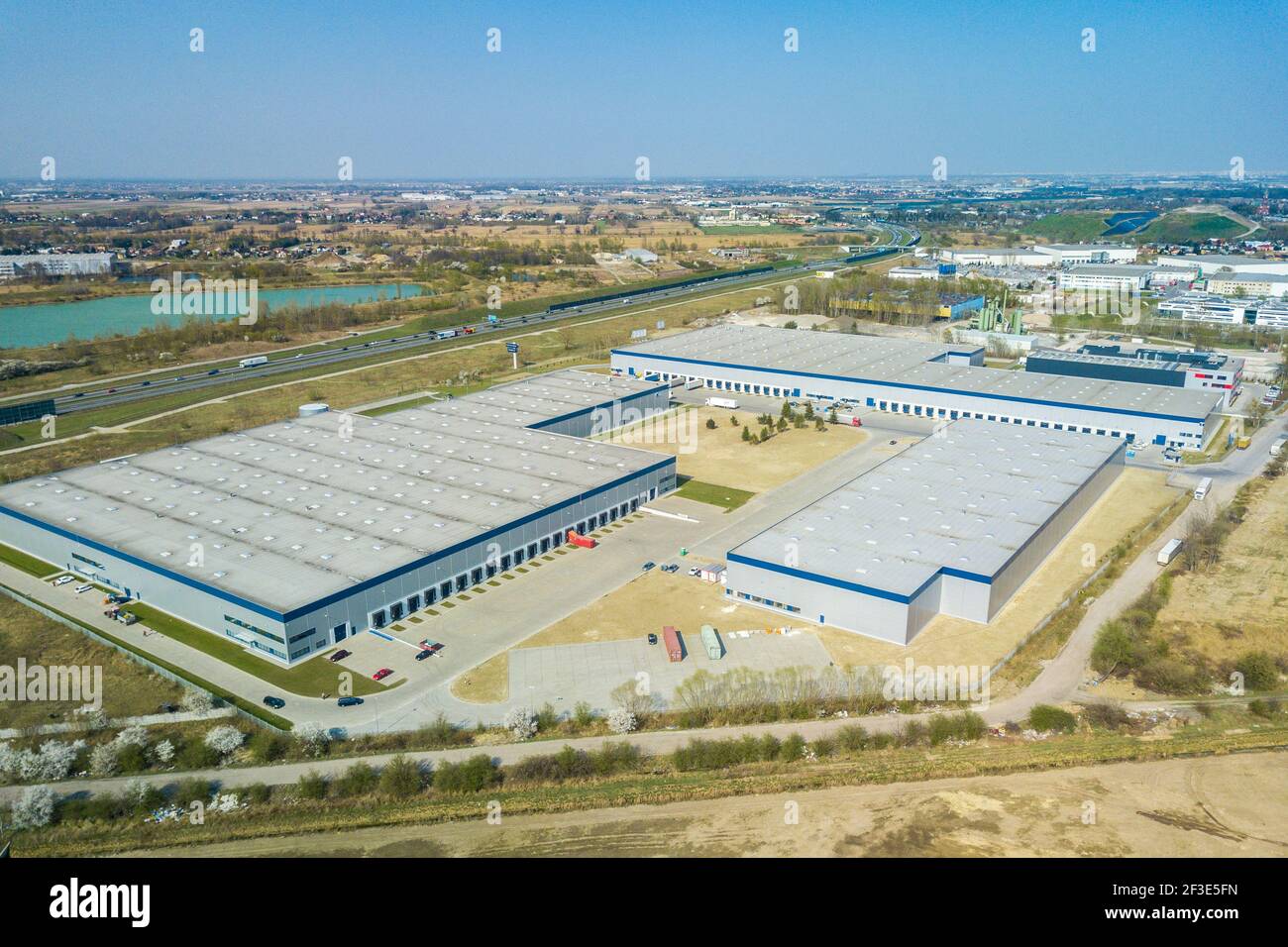 Aerial view from drone on logistic distribution center buildings near highway. Transport and logistics concept. Stock Photo