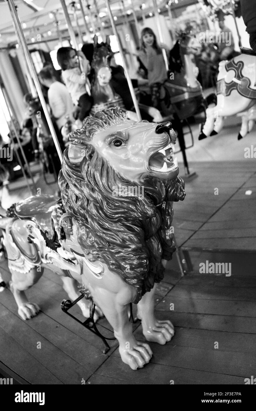 Carousel Lion with children in the background, located in Pullen Park in Raleigh, North Carolina, USA Stock Photo