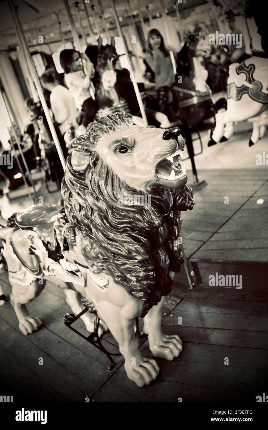 Carousel Lion with children in the background, located in Pullen Park in Raleigh, North Carolina, USA Stock Photo