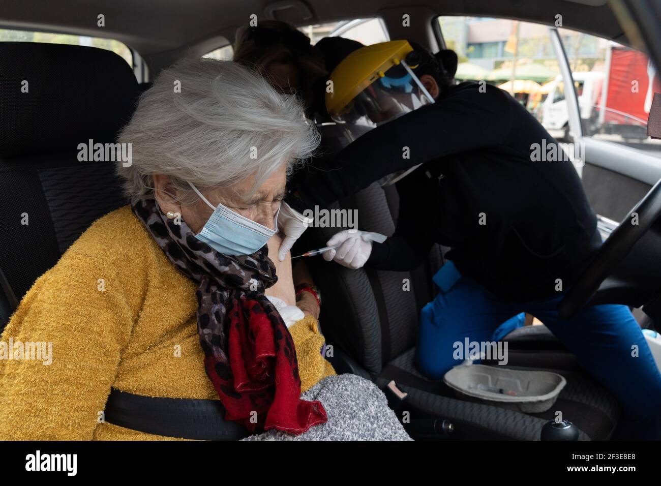 March 16, 2021, Santiago, Metropolitana, Chile: A woman is vaccinated with her second dose of the Sinovac COVID-19 vaccine at a drive-thru vaccination site in Santiago, Chile. So far, almost 5 million people have been vaccinated in the country, and 41% of them with the second dose. (Credit Image: © Matias Basualdo/ZUMA Wire) Stock Photo