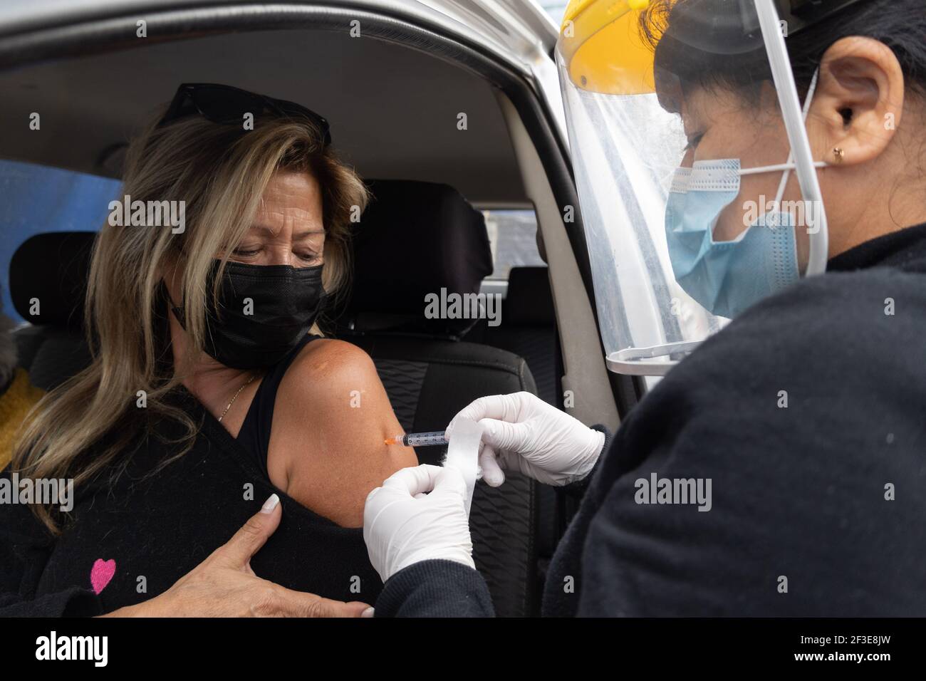 Santiago, Metropolitana, Chile. 16th Mar, 2021. A woman is vaccinated with a dose of the Sinovac COVID-19 vaccine at a drive-thru vaccination site in Santiago, Chile. So far, almost 5 million people have been vaccinated in the country, and 41% of them with the second dose. Credit: Matias Basualdo/ZUMA Wire/Alamy Live News Stock Photo