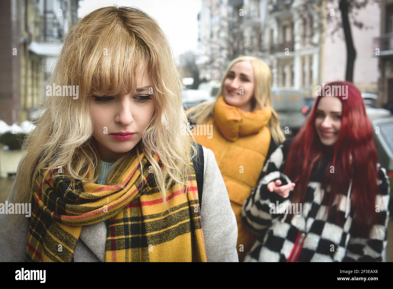 a young depressed student girl with blonde hair who is bullied by her teenage peers, disturbed by feelings of despair and suffering from oppression. s Stock Photo