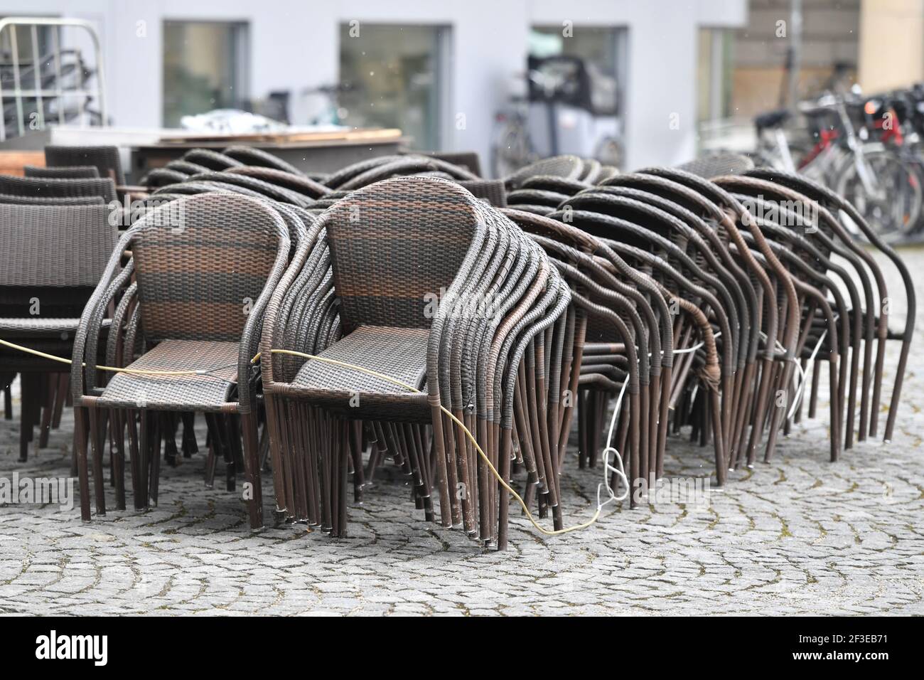 Topic picture: Coronavirus pandemic / consequences for gastronomy: stacked chairs and tables in front of a restaurant, | usage worldwide Stock Photo