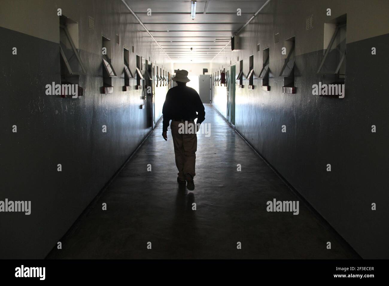 An ex-prisoner walks through the halls of the former prison on Robben Island off the coast of Cape Town, South Africa Stock Photo