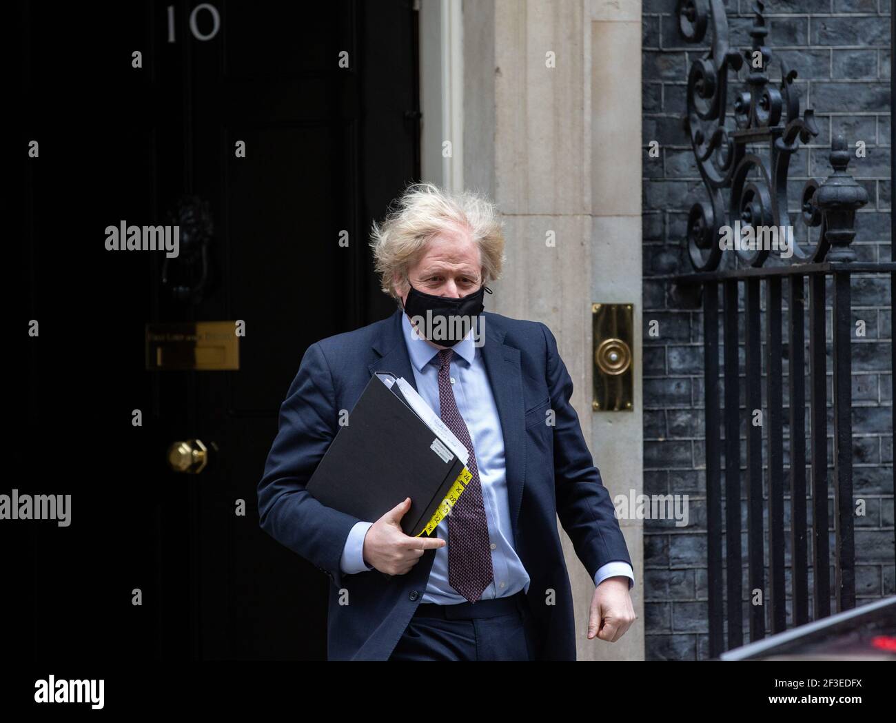 Prime Minister, Boris Johnson, leaves Number 10 to go to Parliament to give a speech on Global Britain and to reassure people about the Covid vaccine. Stock Photo