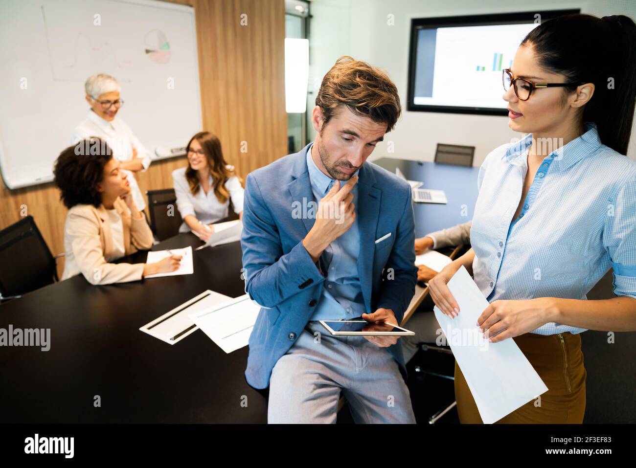 Collaboration and analysis by business people working in office Stock ...