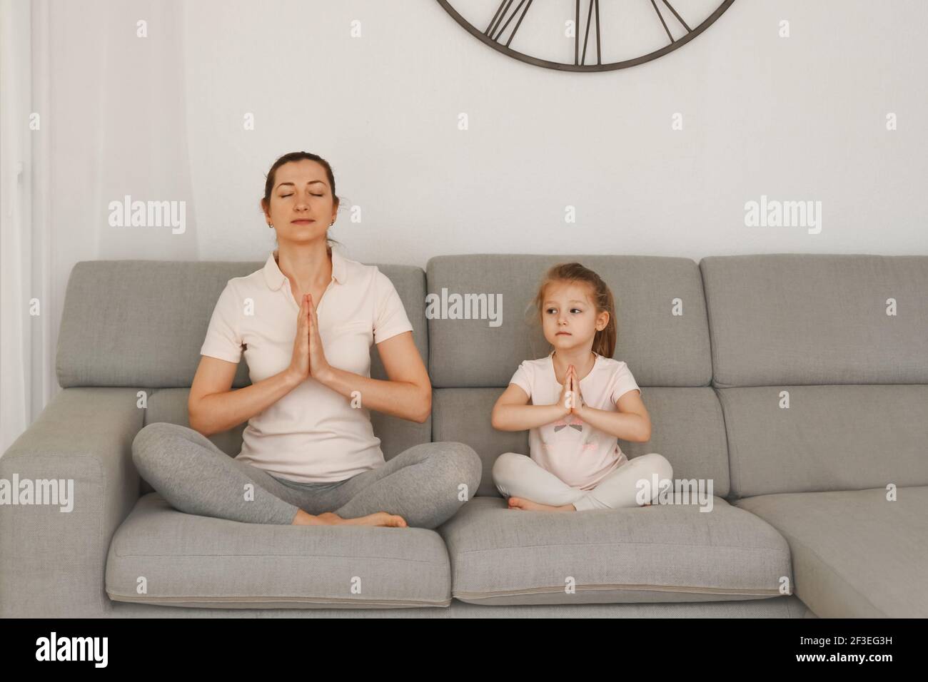 Mother and daughter doing yoga at home Stock Photo - Alamy