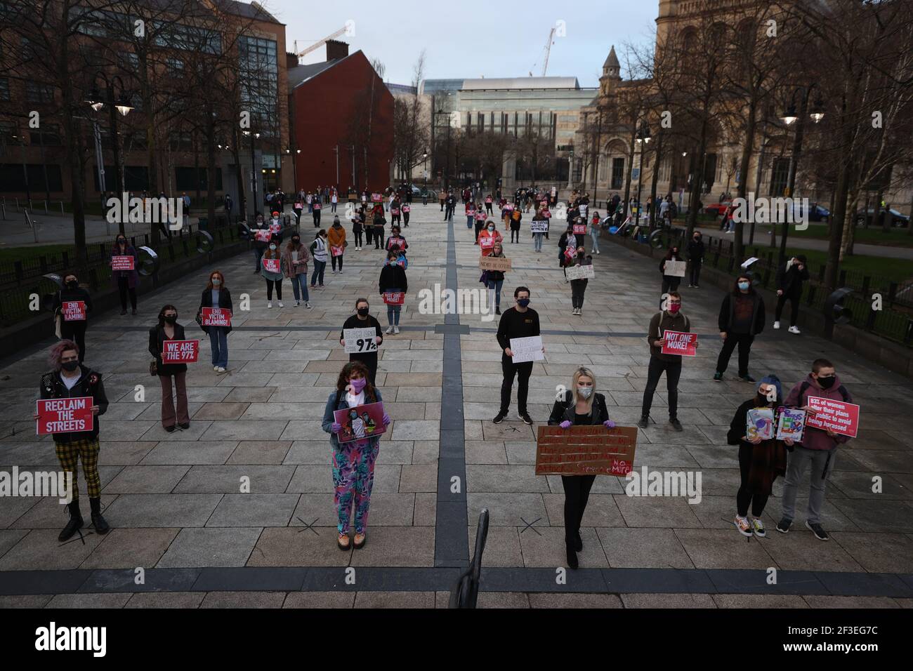 People in Writer's Square, Belfast, taking part in a demonstration against gender violence and to defend the right to protest following the murder of Sarah Everard and subsequent police actions at a vigil in London. Picture date: Tuesday March 16, 2021. Stock Photo