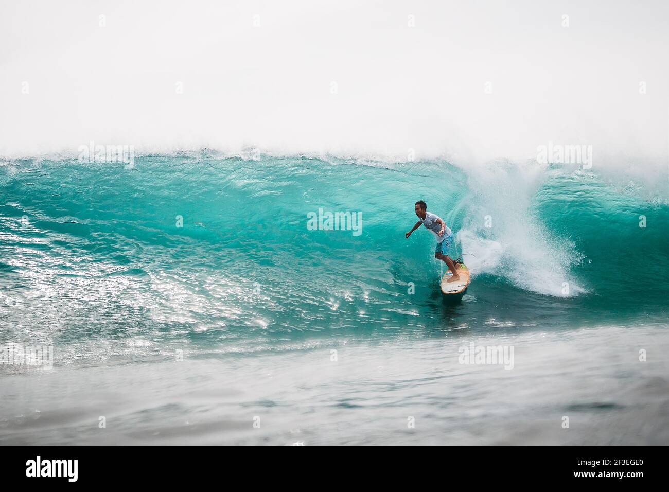 December 30, 2020. Bali, Indonesia. Surfer ride on surfboard at ocean