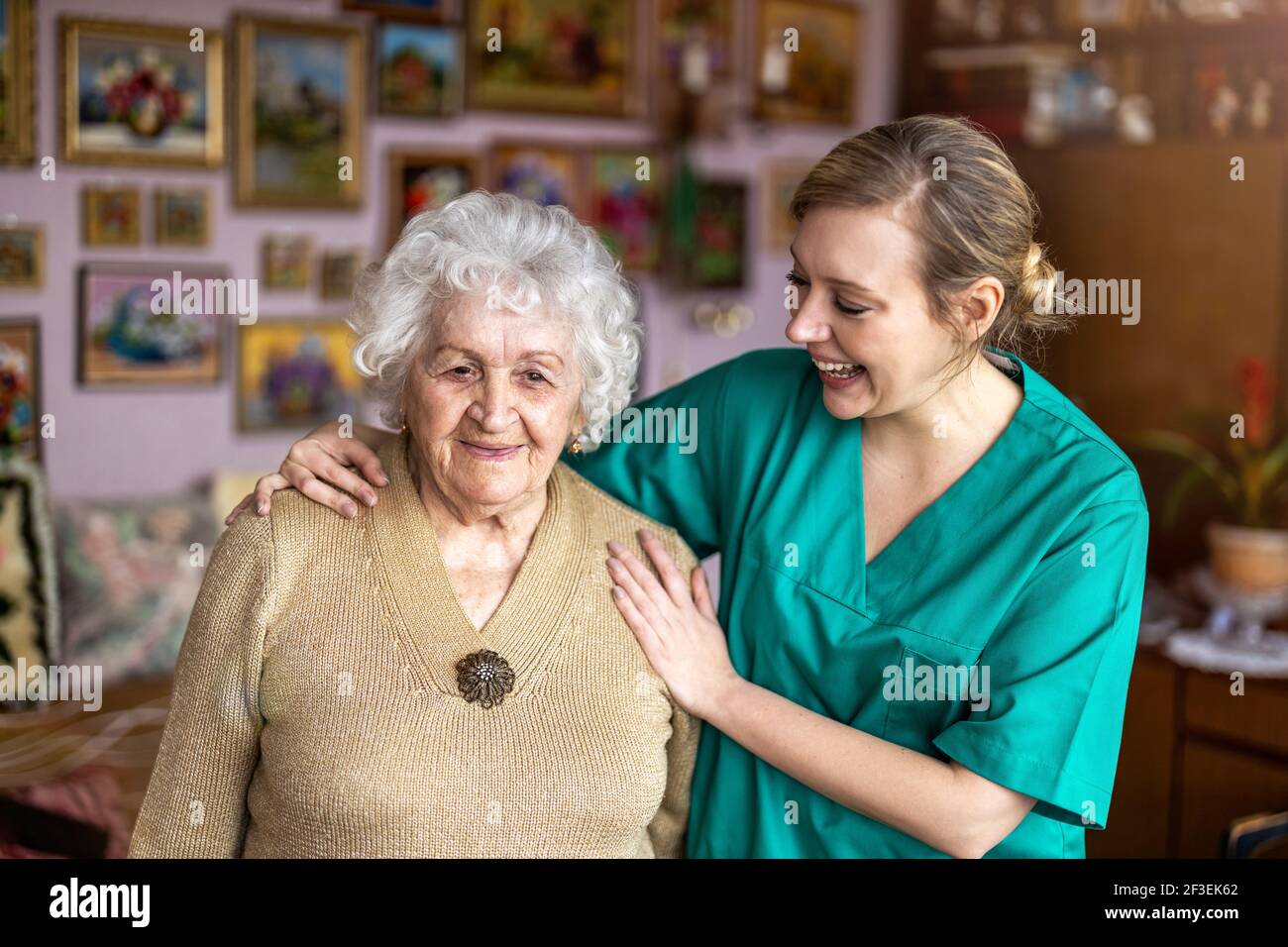 Friendly nurse supporting an elderly lady Stock Photo