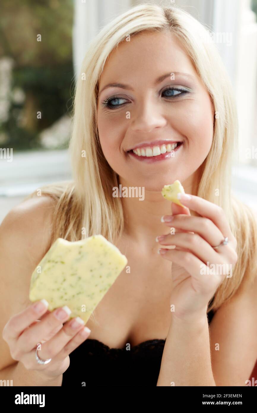 Woman eating cheese Stock Photo Alamy