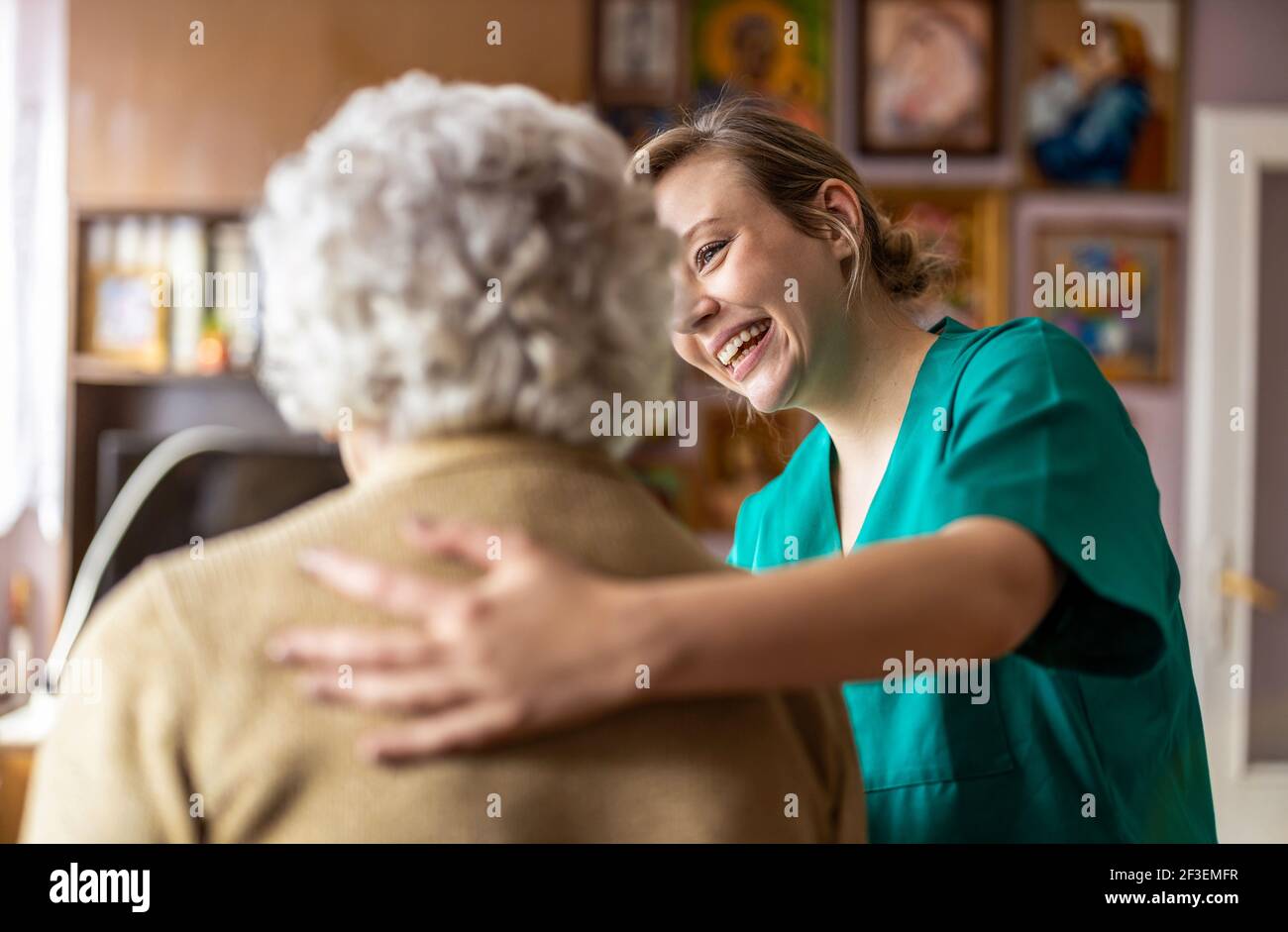 Friendly nurse supporting an elderly lady Stock Photo