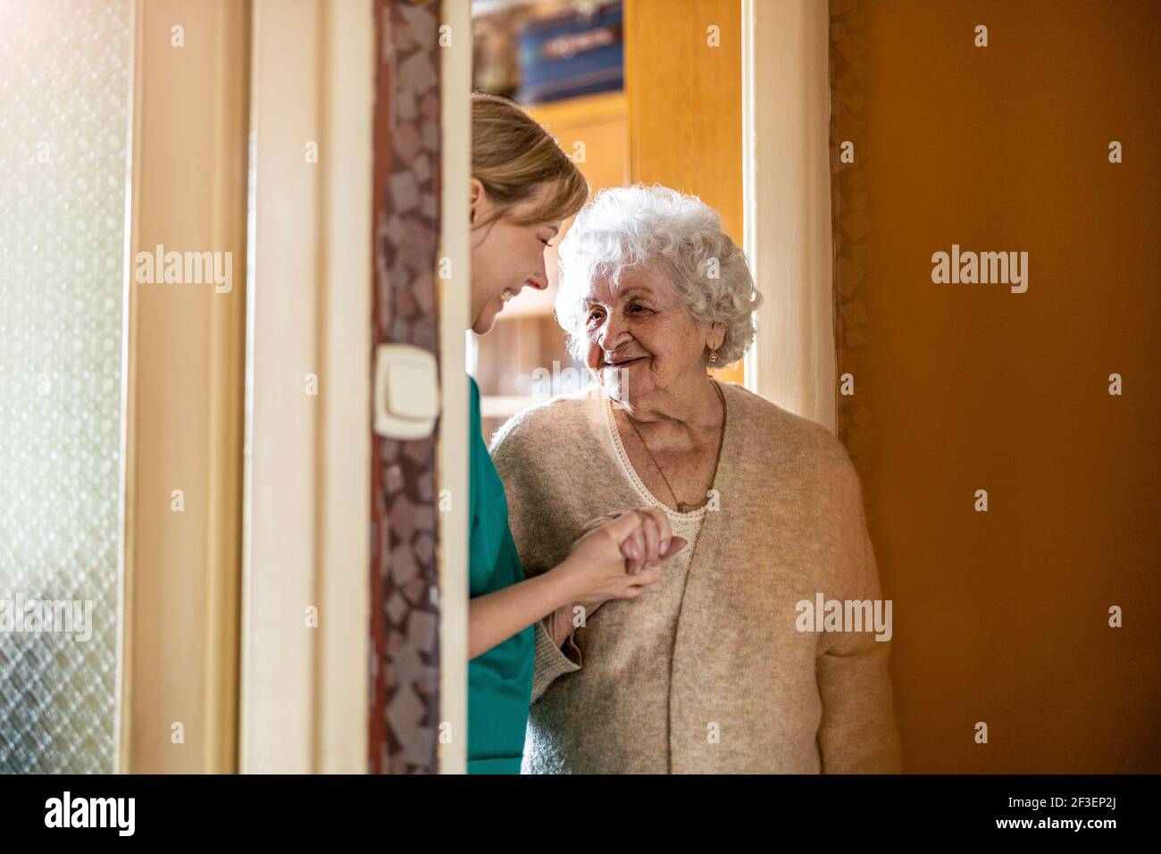 Friendly nurse supporting an elderly lady Stock Photo