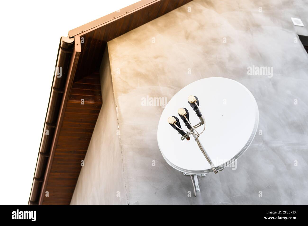Satellite dish antenna for receiving a TV signal is fixed on the facade