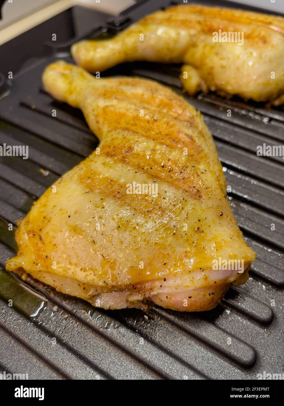 Homemade grilled chicken thighs. Preparing chicken meat on electric