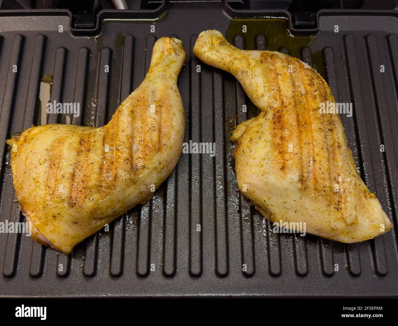 Homemade grilled chicken thighs. Preparing chicken meat on electric