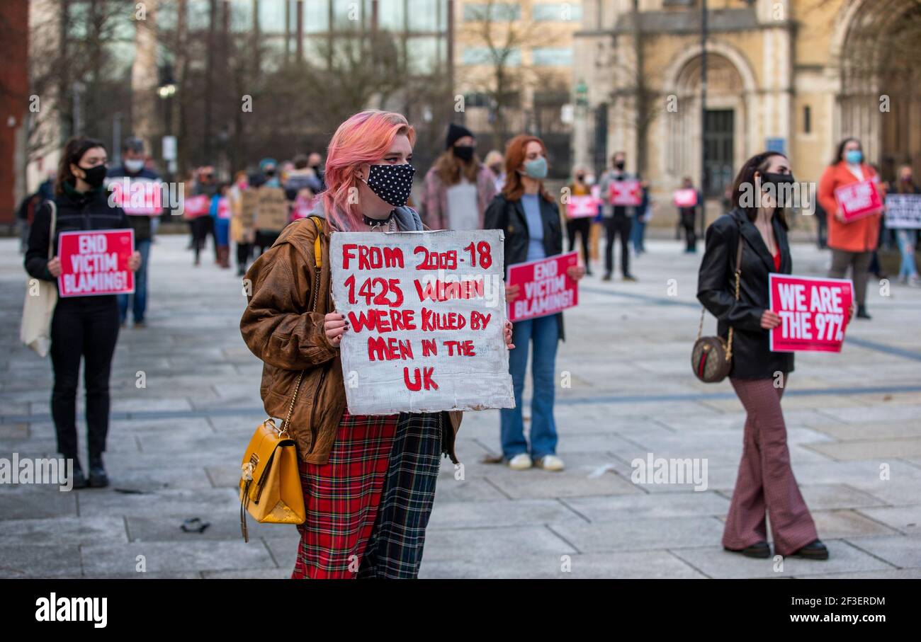 People in Writer's Square, Belfast, taking part in a demonstration against gender violence and to defend the right to protest following the murder of Sarah Everard and subsequent police actions at a vigil in London. Picture date: Tuesday March 16, 2021. Stock Photo