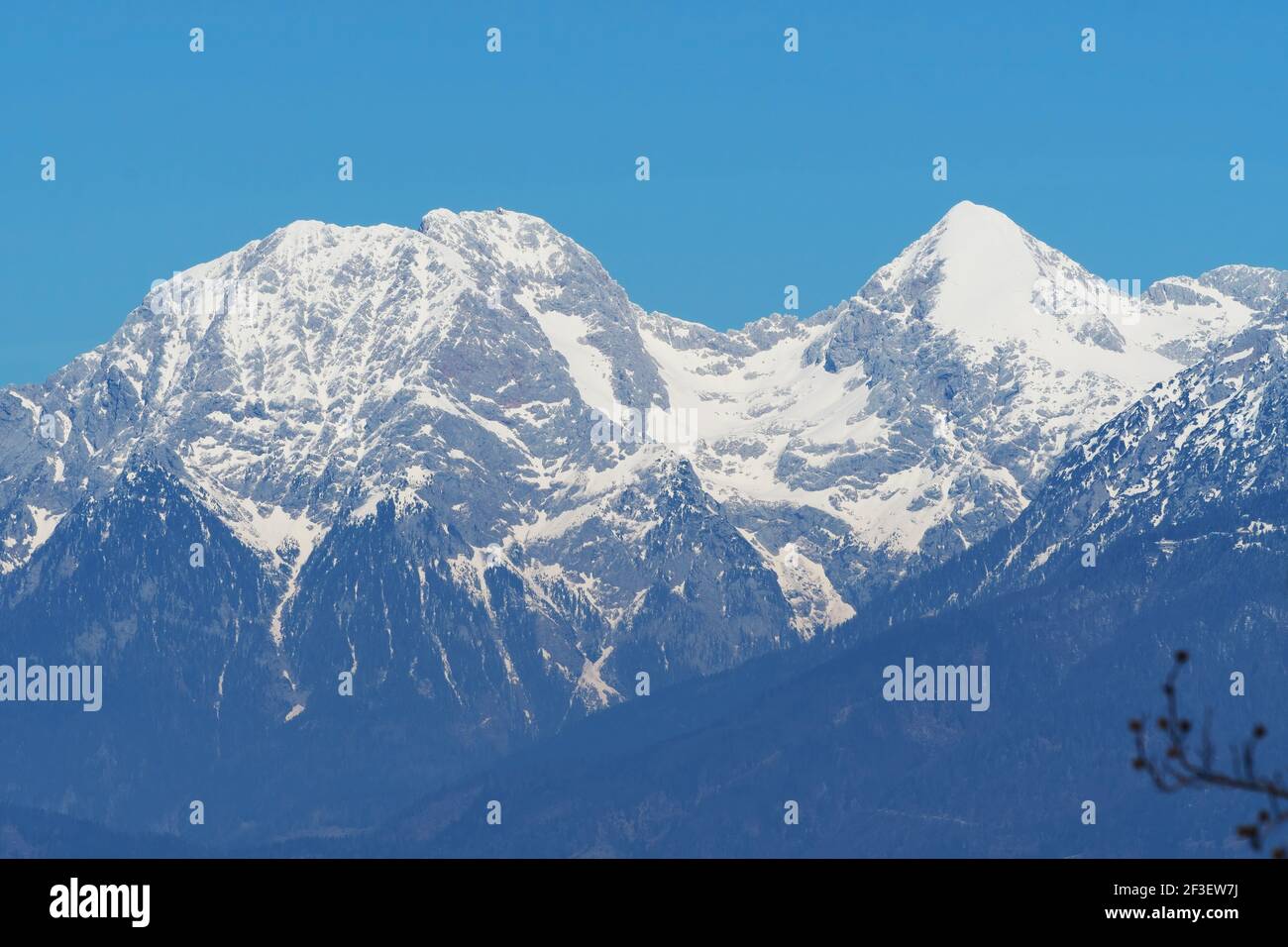 Beautiful view of snow-capped Alpine peaks and mountain pass on a sunny day in Slovenia. Mountaineering, weather, climatology and travel concepts Stock Photo