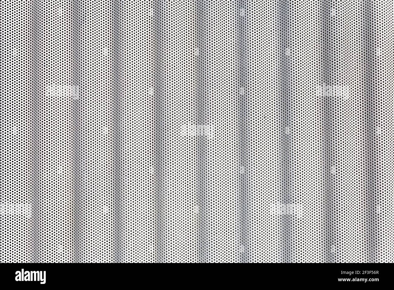 white metal surface with multiple small holes Stock Photo