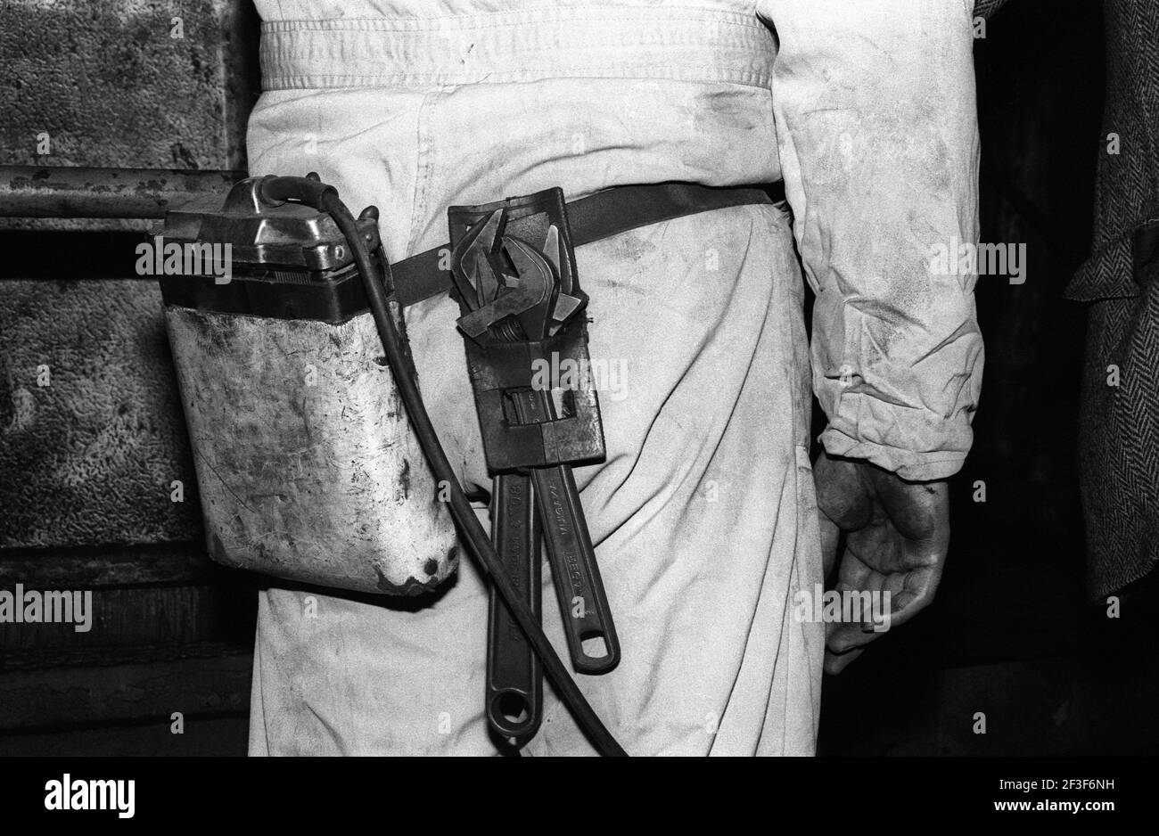 Man with headlamp battery pack and tool kit at Monkwearmouth Colliery Stock Photo