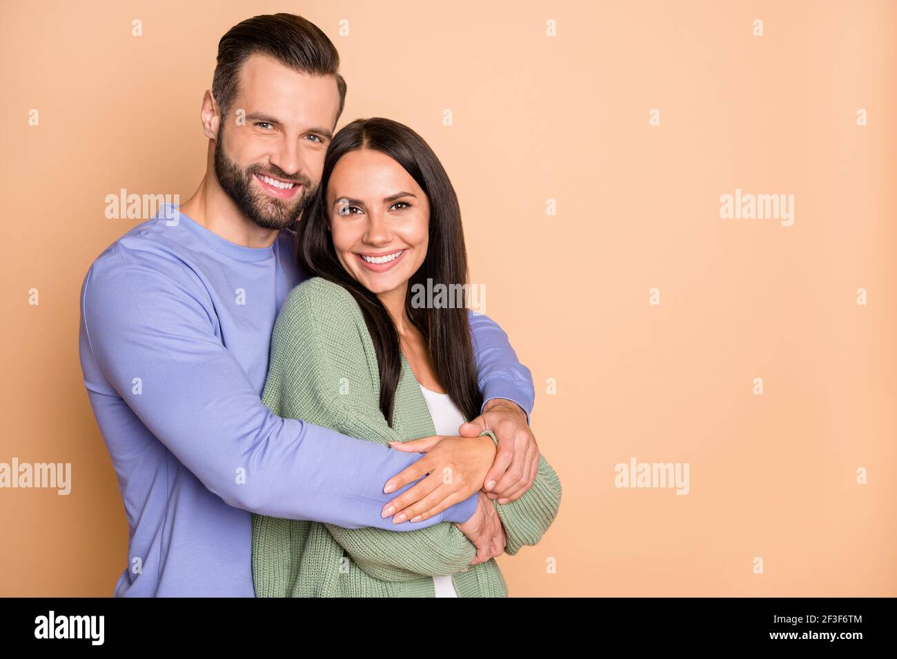Photo of optimistic couple hug with empty space wear cardigan sweater ...