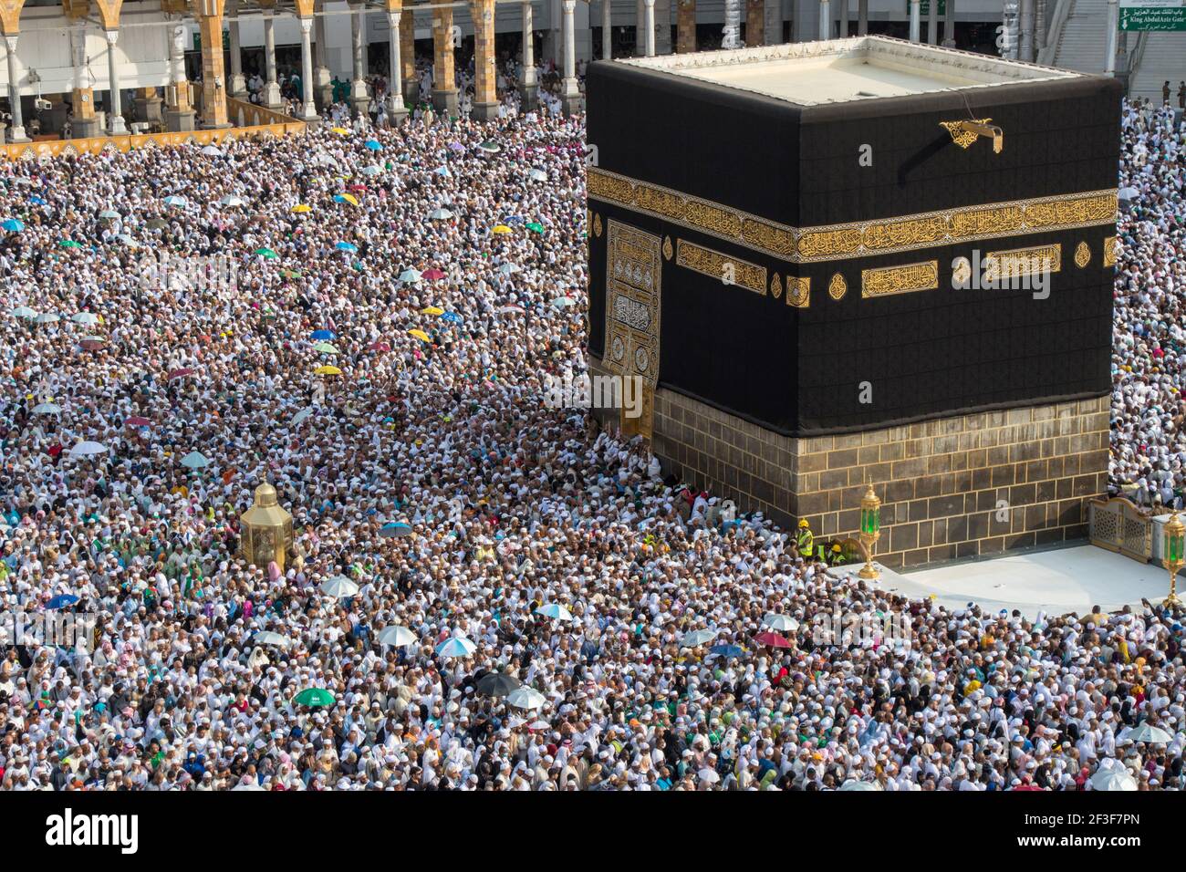 Muslim pilgrims revolving around the Kaaba in Mecca Saudi Arabia. Muslim people praying together at holy place. Stock Photo