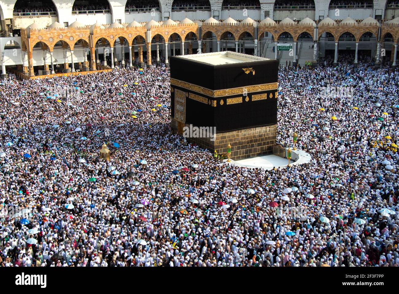Muslim pilgrims revolving around the Kaaba in Mecca Saudi Arabia. Muslim people praying together at holy place. Stock Photo