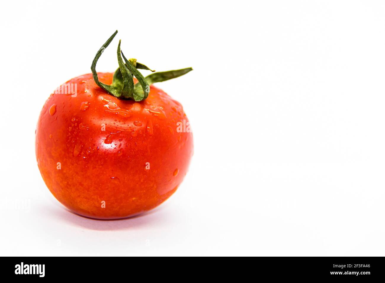 A closeup of a fresh ripe tomato isolated on a white background Stock ...