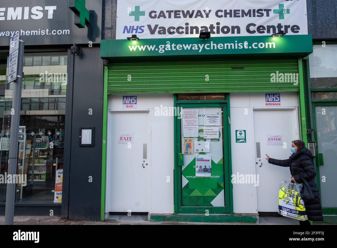 A woman enteres an NHS covid-19 vaccination centre in Finchley, north London, in March 2021. Stock Photo