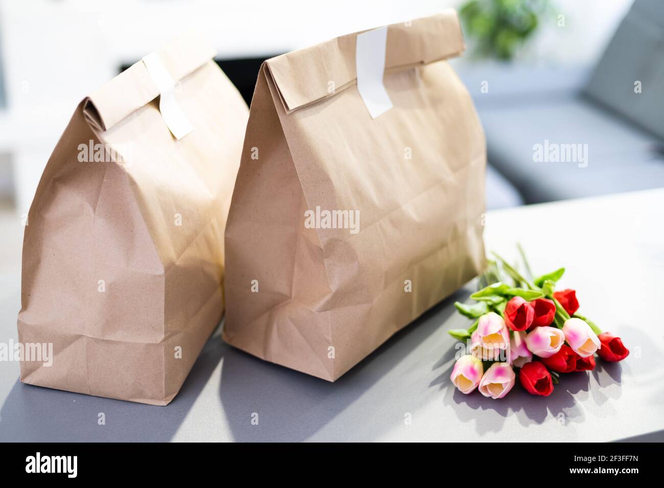 Download Kraft Paper Bags With Blooming Red Tulips Bouquet On Gray Background Flowers And Food Delivery Packaging Banner Copy Space Mockup Donations Help Stock Photo Alamy