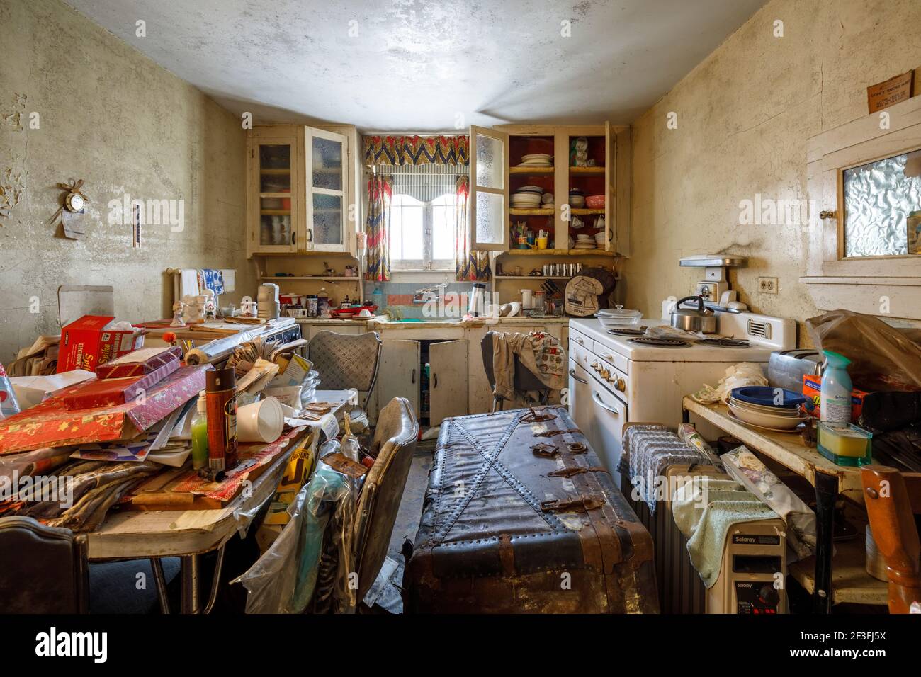 A very messy kitchen inside of an abandoned house. Stock Photo