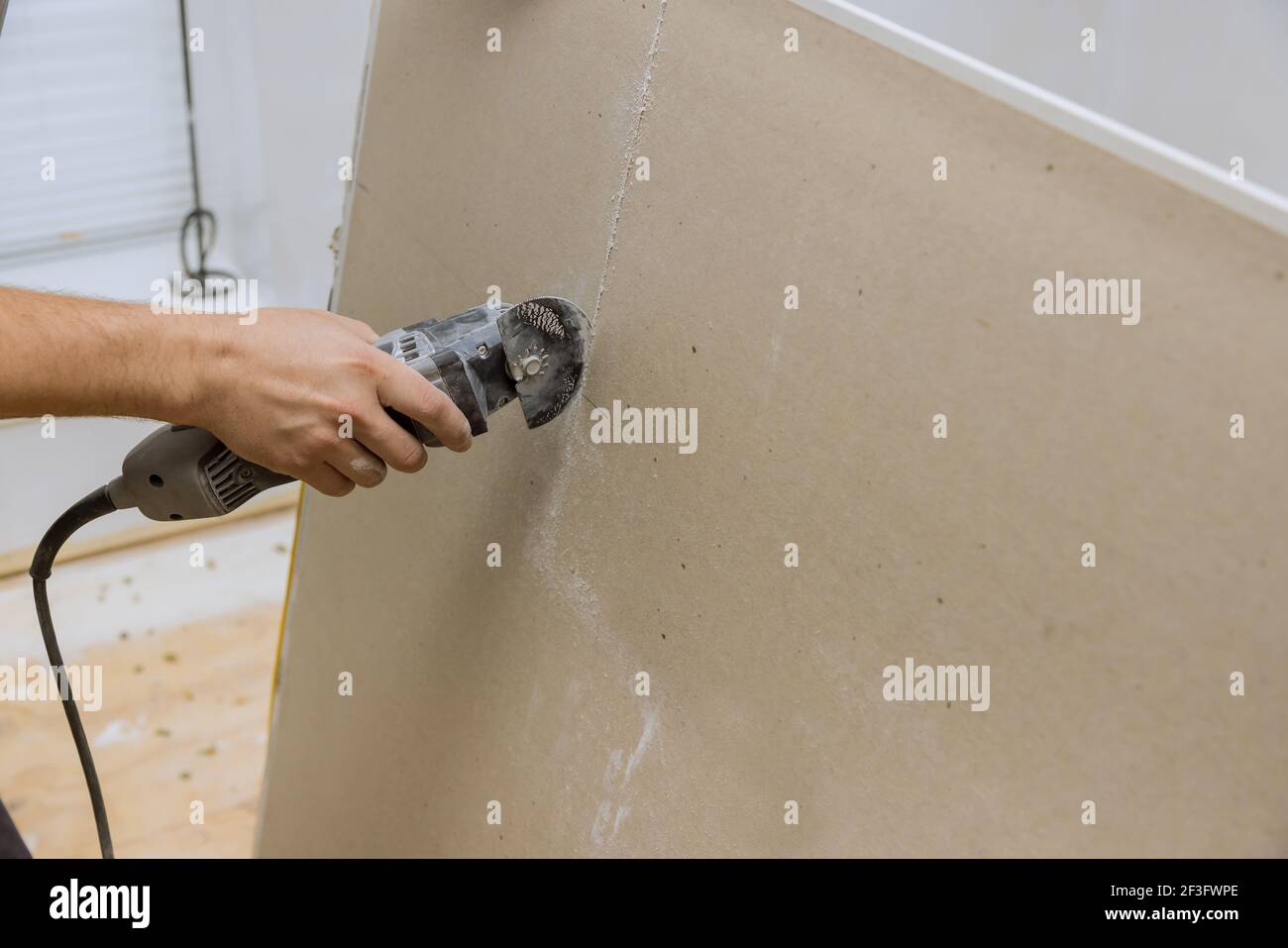 Angle hand electric power tools cut drywall sheet Stock Photo Alamy