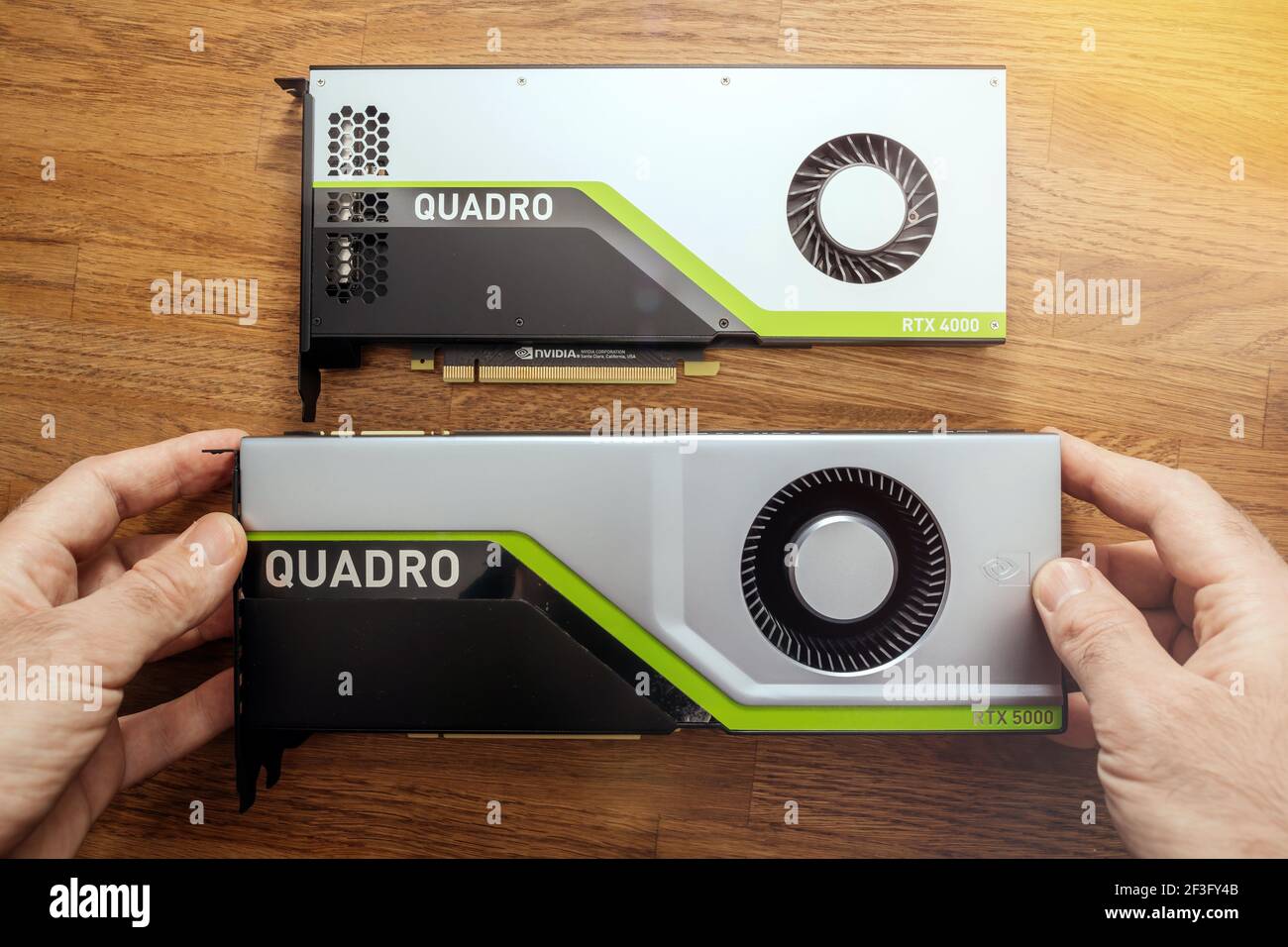 Senior engineer hands pov holding looking comparing two new GPU Nvidia Quadro  RTX 4000 RTX 5000 based on the Turing microarchitecture, and features Stock  Photo - Alamy