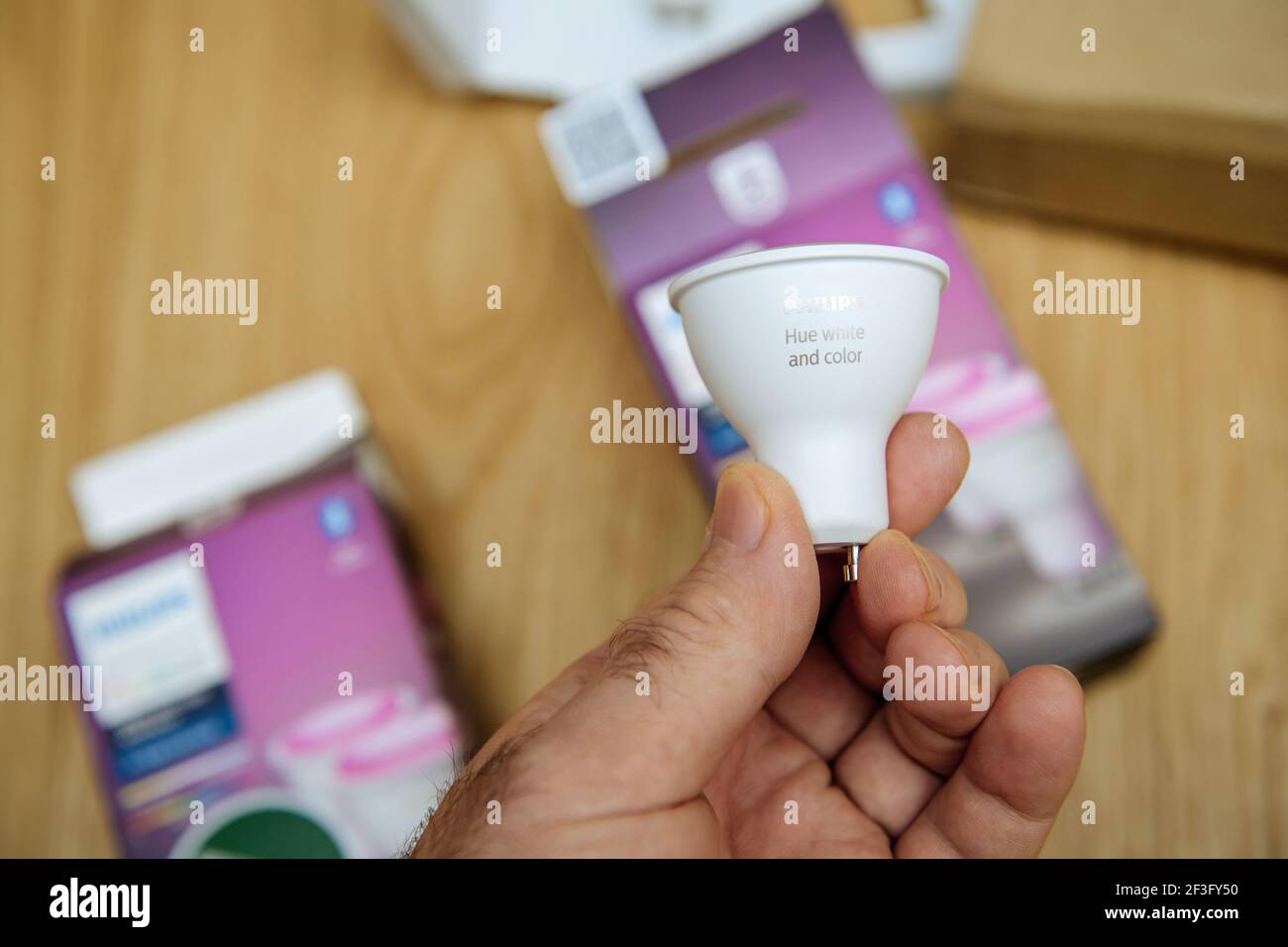 POV male hand holding new Philips Hue GU10 color lamp right after unboxing  Stock Photo - Alamy