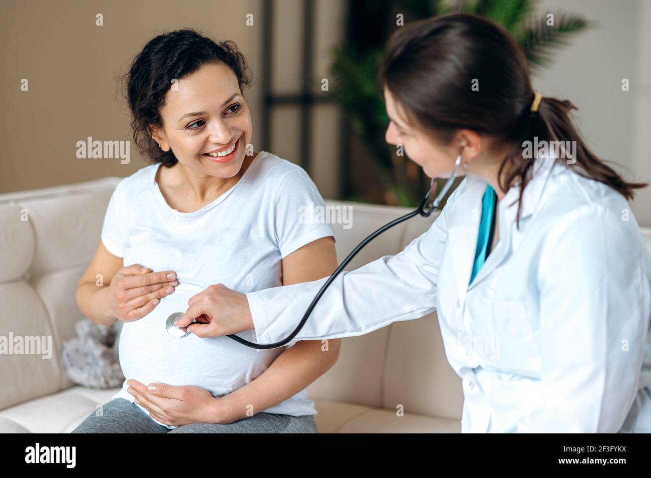 Doctor listening pregnant belly stethoscope hires stock photography