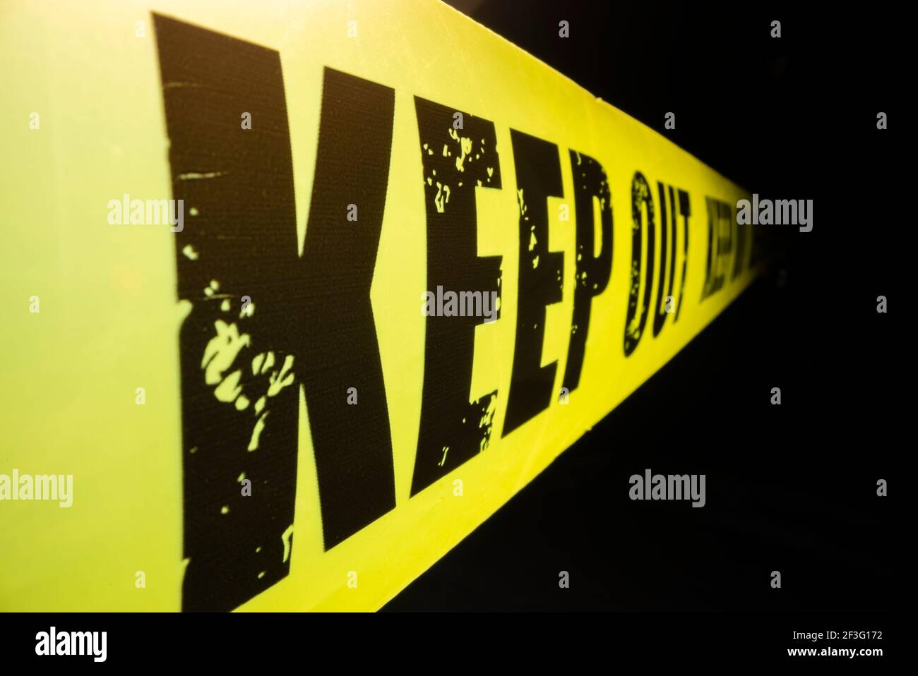 Close-up view of keep out tape against dark background Stock Photo