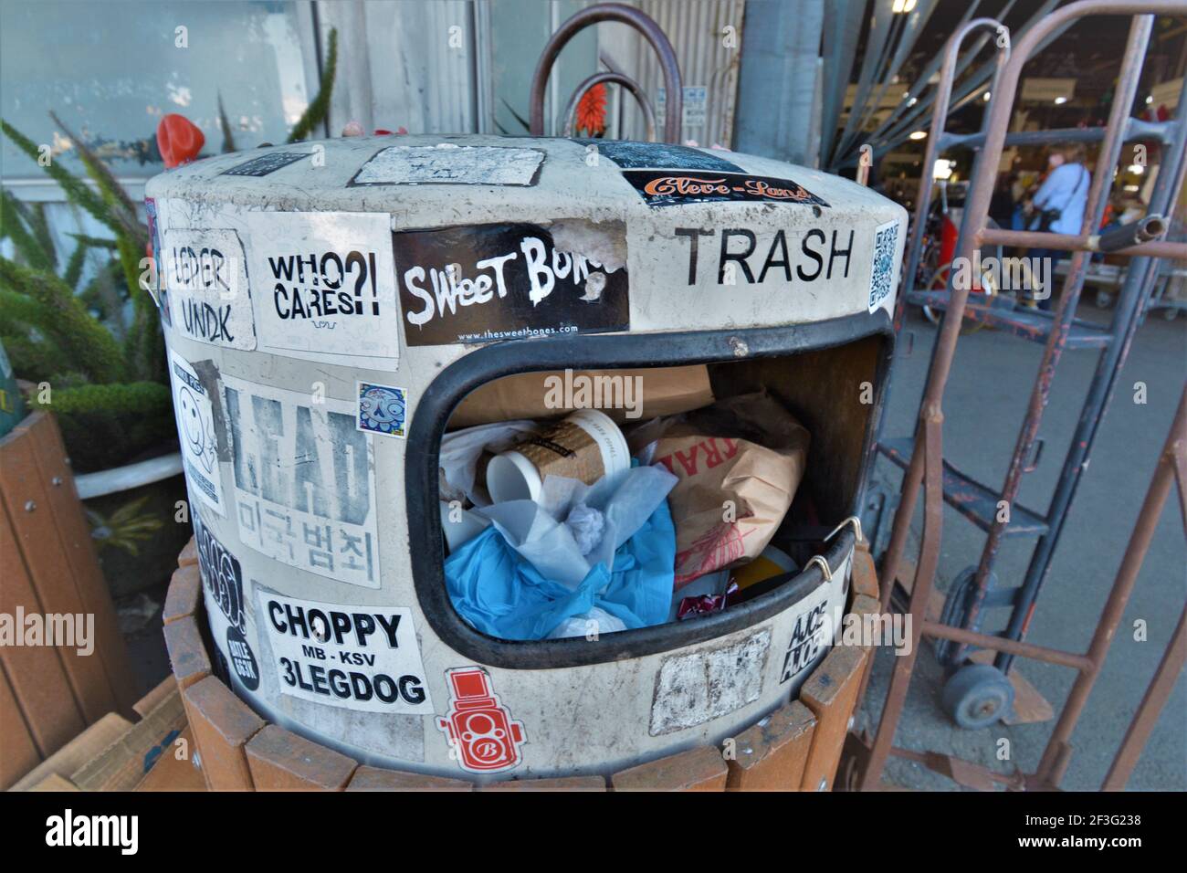 Over full trash can in Berkeley near where so many homeless put garbage