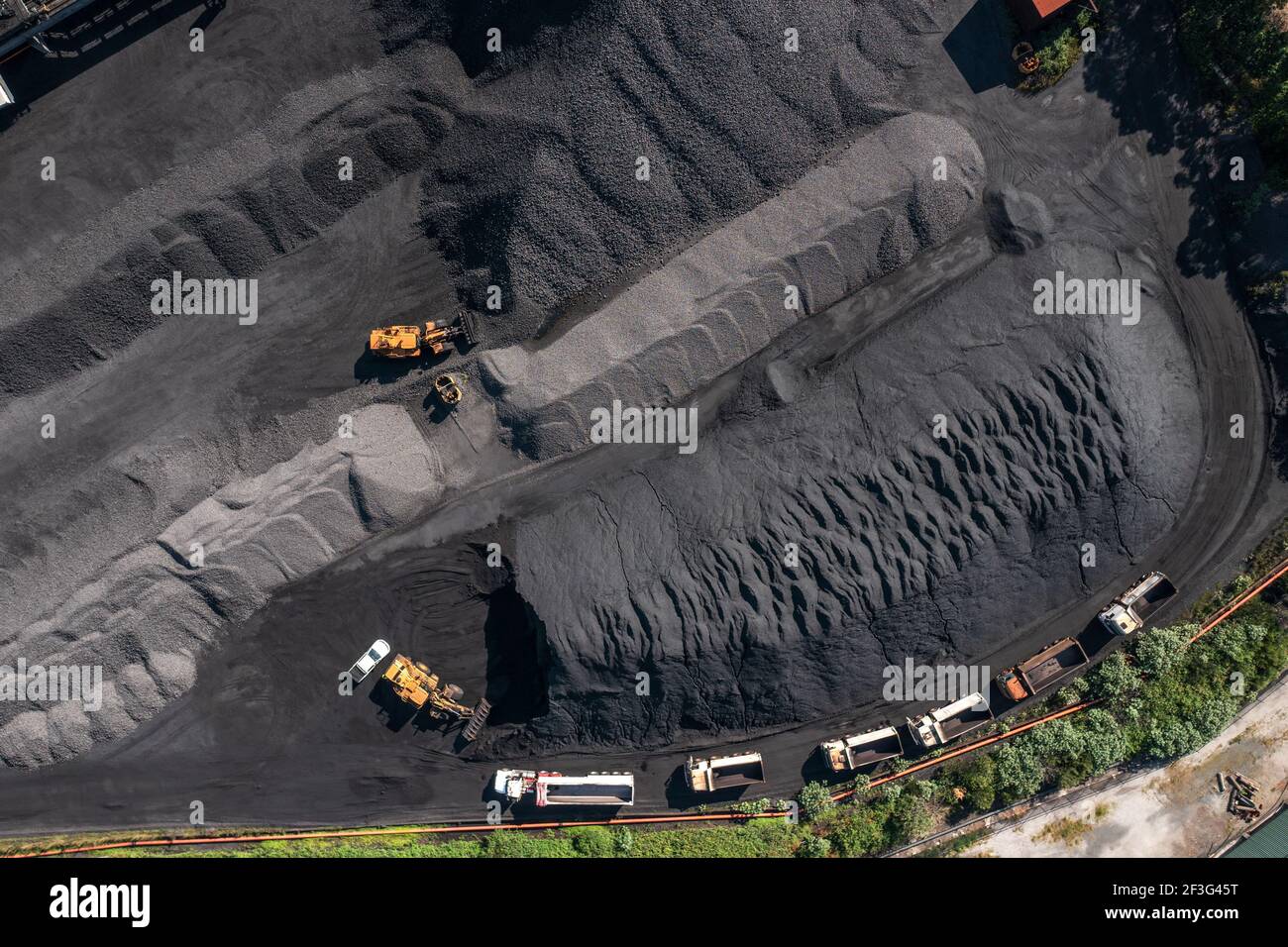 Top down aerial view of trucks lined up for loading coal at Port Kembla, NSW, Australia. Stock Photo