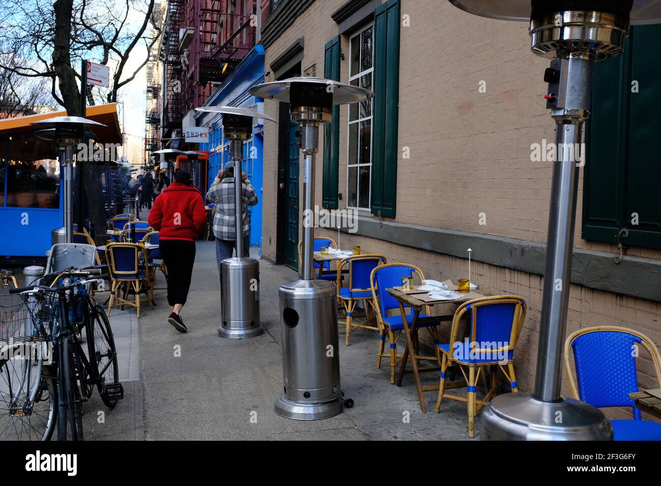 Outdoor dining area with outdoor patio heaters occupied the sidewalk of MacDougal Street during Covid-19 pandemic.Greenwich Village.Manhattan.New York City.USA Stock Photo