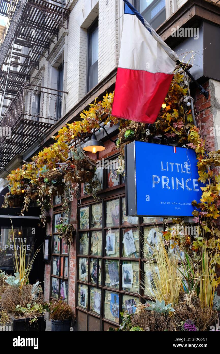 Exterior view of Little Prince Bistro Non-Classique with a French flag in SoHo.Manhattan.New York City.USA Stock Photo