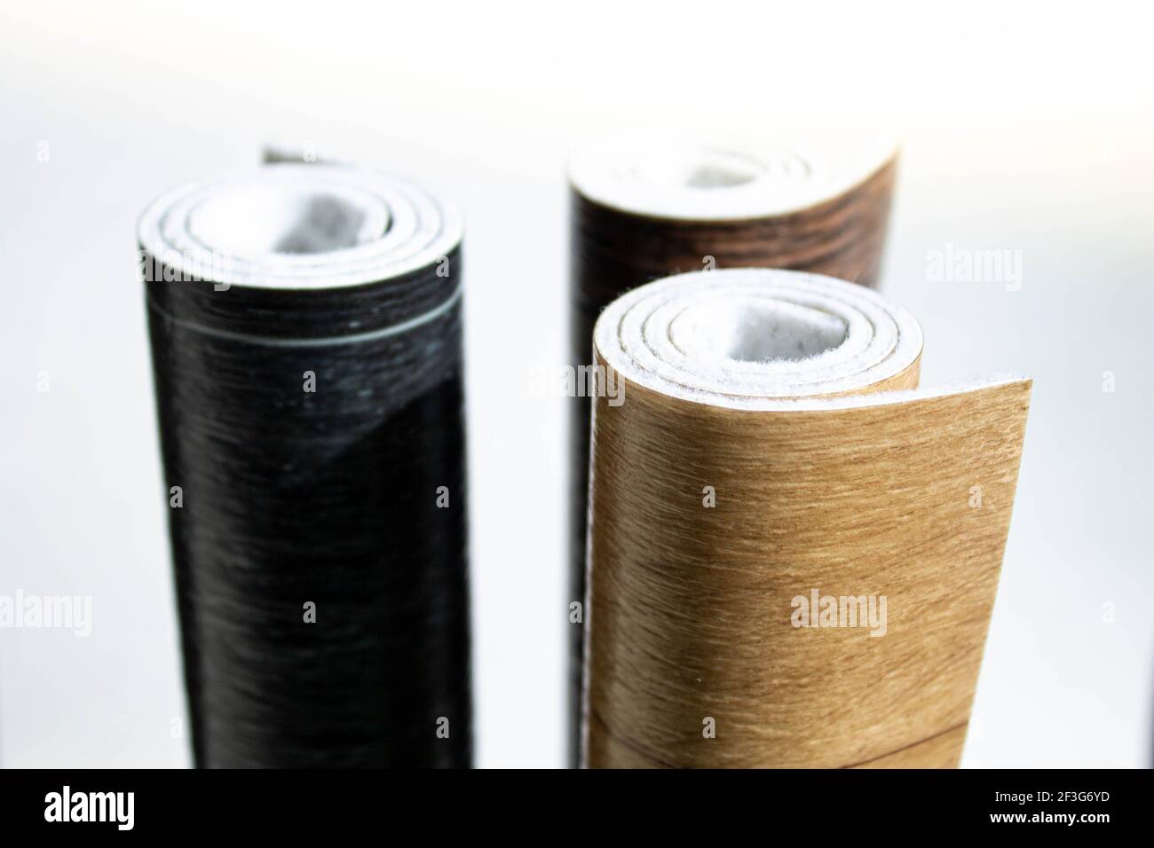 Linoleum. Three rolls of linoleum on a white background. Floor coverings for home use. Linoleum
