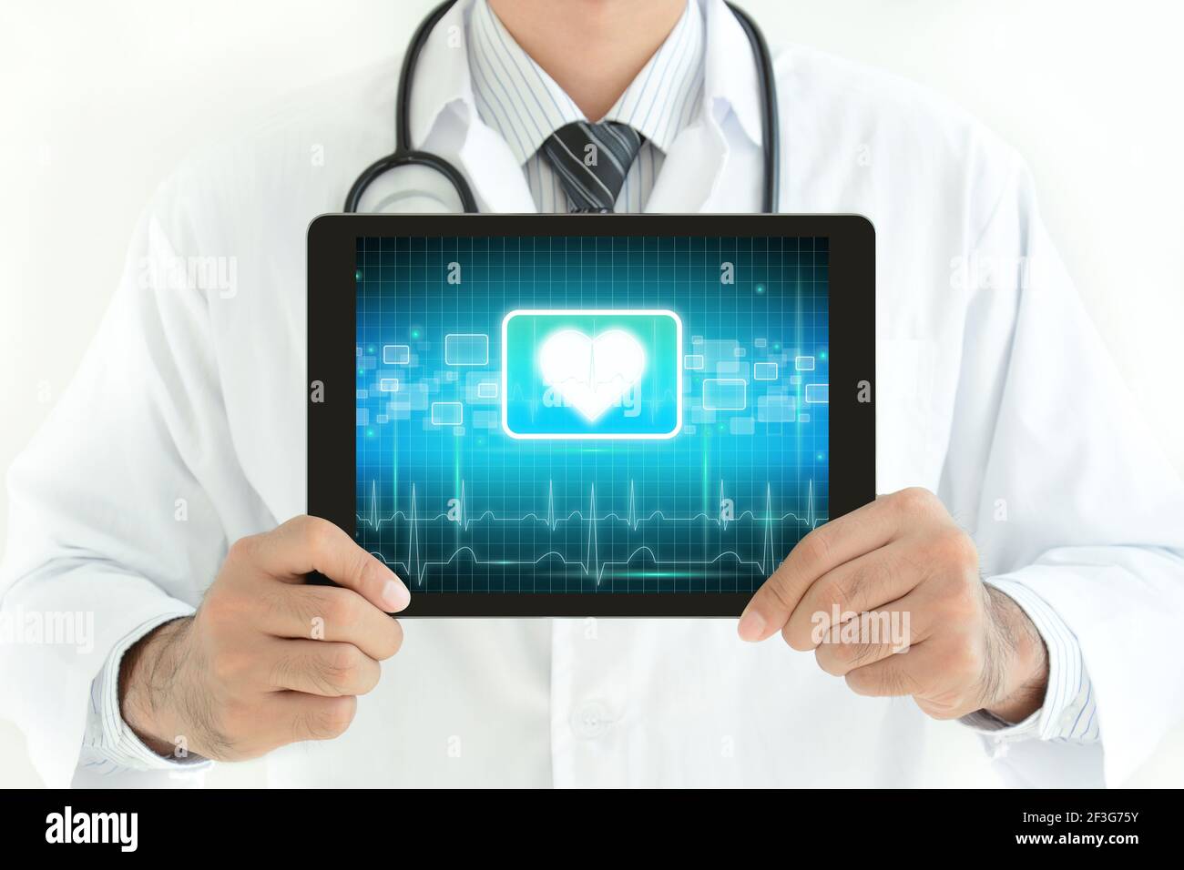 Doctor holding tablet pc with heart sign on screen Stock Photo - Alamy