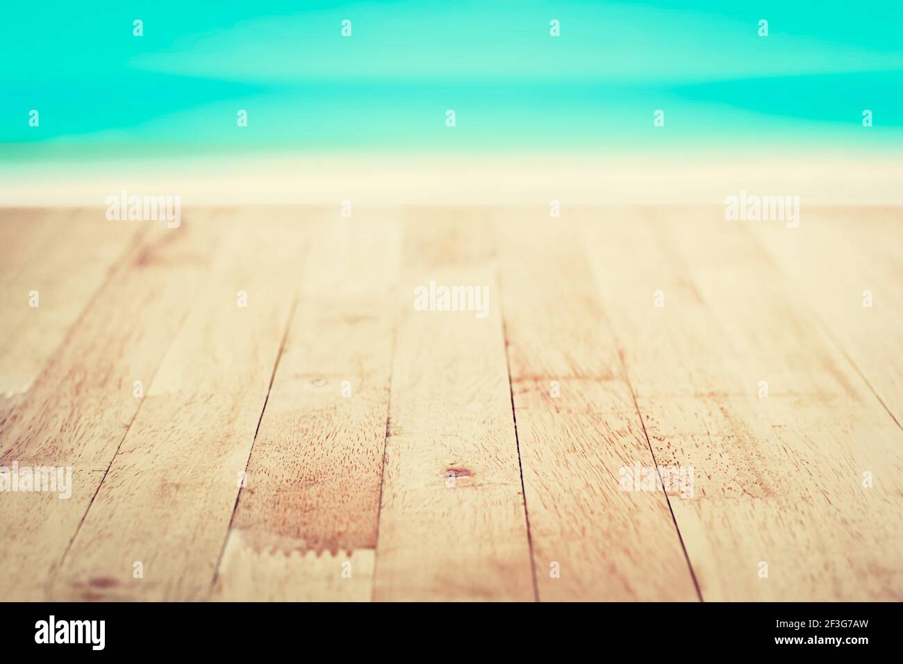 Wood table top on blurred beach background, vintage tone - can be used for montage or display your products Stock Photo