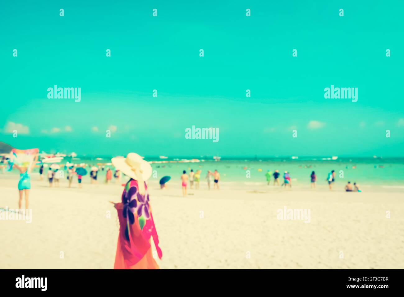 Blurred people on white sand beach with blue sea an sky background - vintage tone Stock Photo
