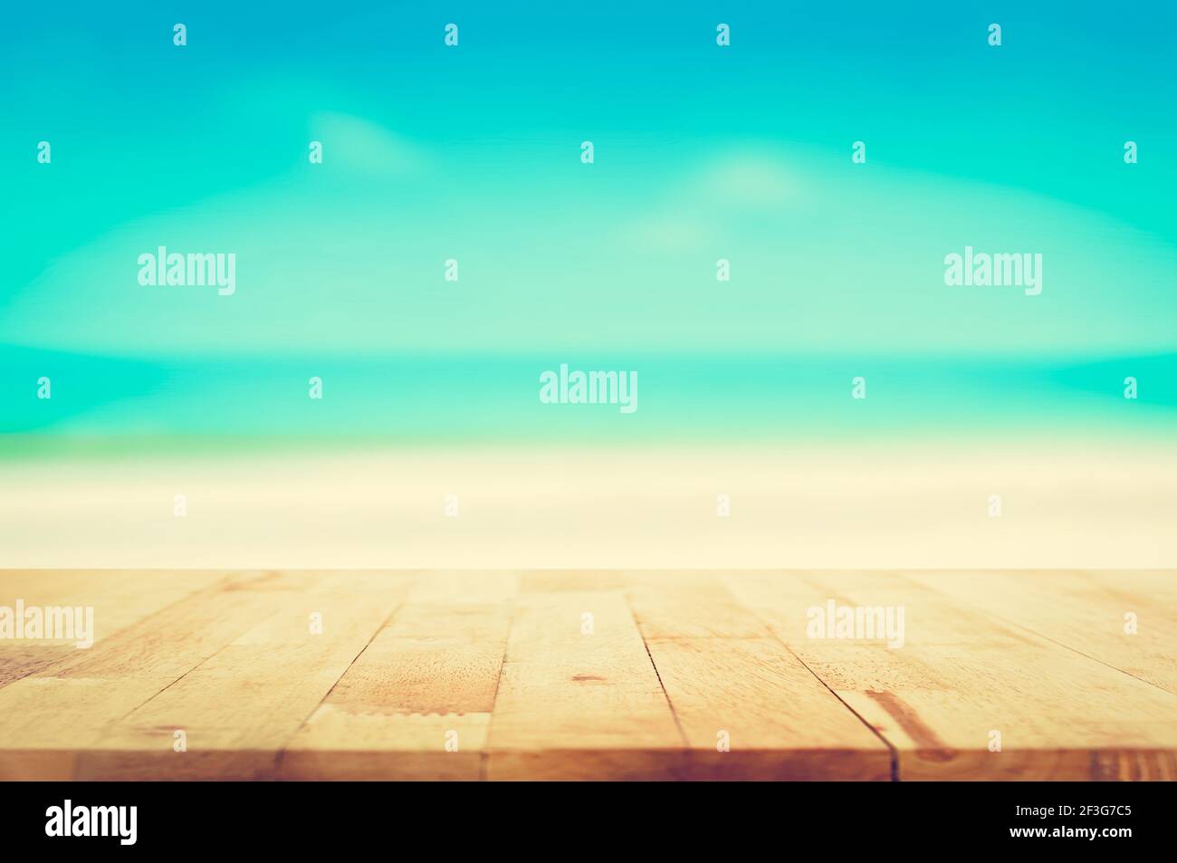Wood table top on blurred beach background, vintage tone - can be used for display or montage your products Stock Photo