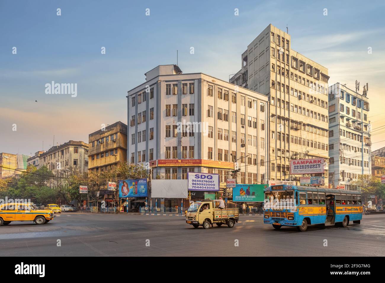 City road intersection with public transport vehicles and view of ...