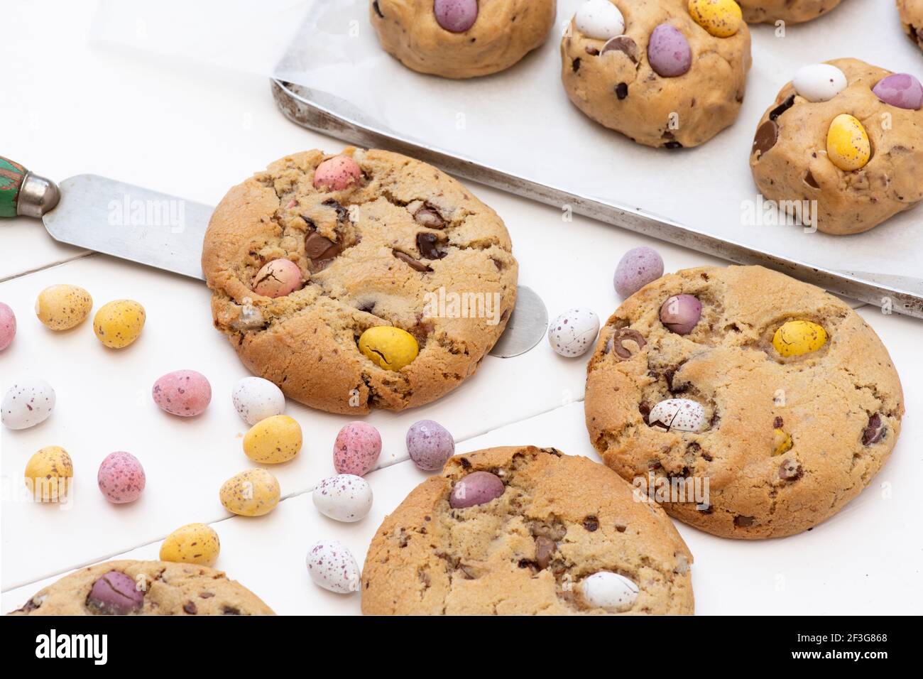 Homemade chocolate mini egg cookies and the raw cookie dough on a baking tray Stock Photo