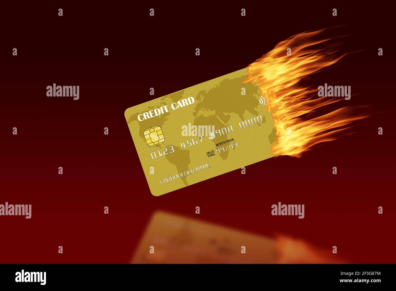 Golden credit card burning with trailing fire and copy space against red background. Concept of credit trouble, financial crisis, credit warning, debt Stock Photo