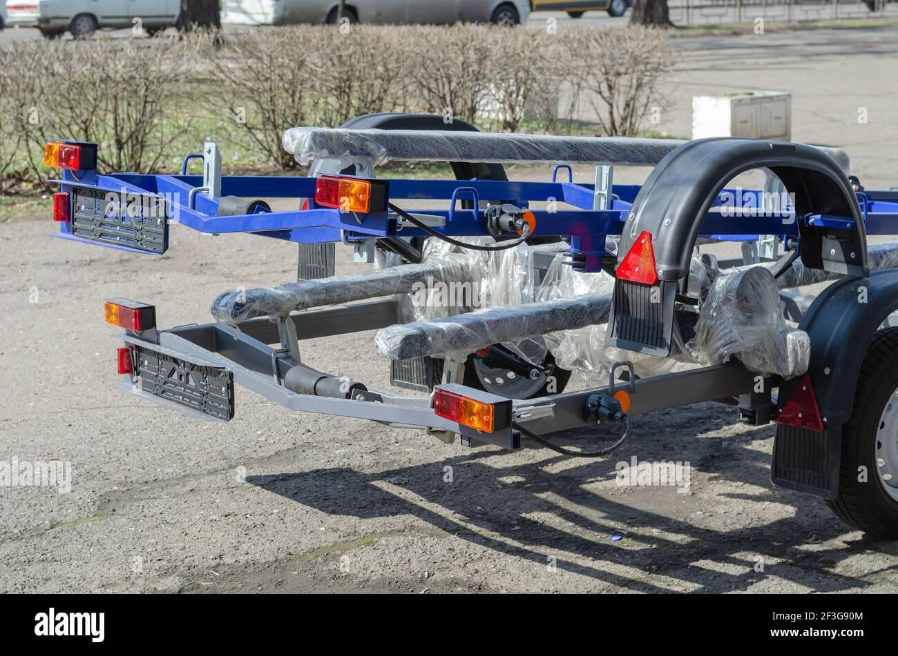 New boat trailers for sale. Rear of vehicles with reflectors. Outdoors