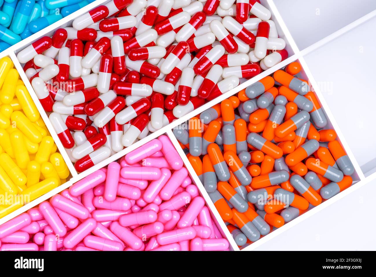 Top view of antibiotic capsule pills in plastic drug tray. Antibiotic resistance concept. Antibiotic drug selection. Drug interactions and pharmacolog Stock Photo